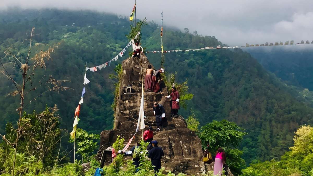 Locals climbing the sacred Do Kelpai Genthey, Rock of Ancient Steps