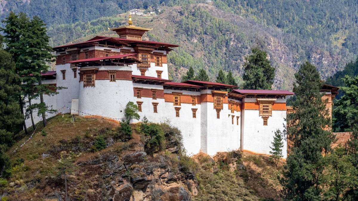Stand before the restored grandeur of Drukgyel Dzong